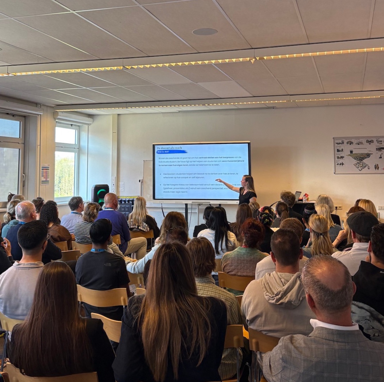 Spreker geeft een presentatie aan een team in een klaslokaal